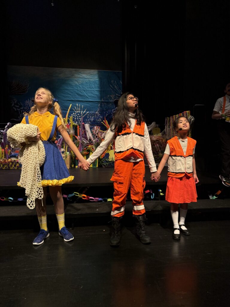 the three student leads of finding nemo sing the finale