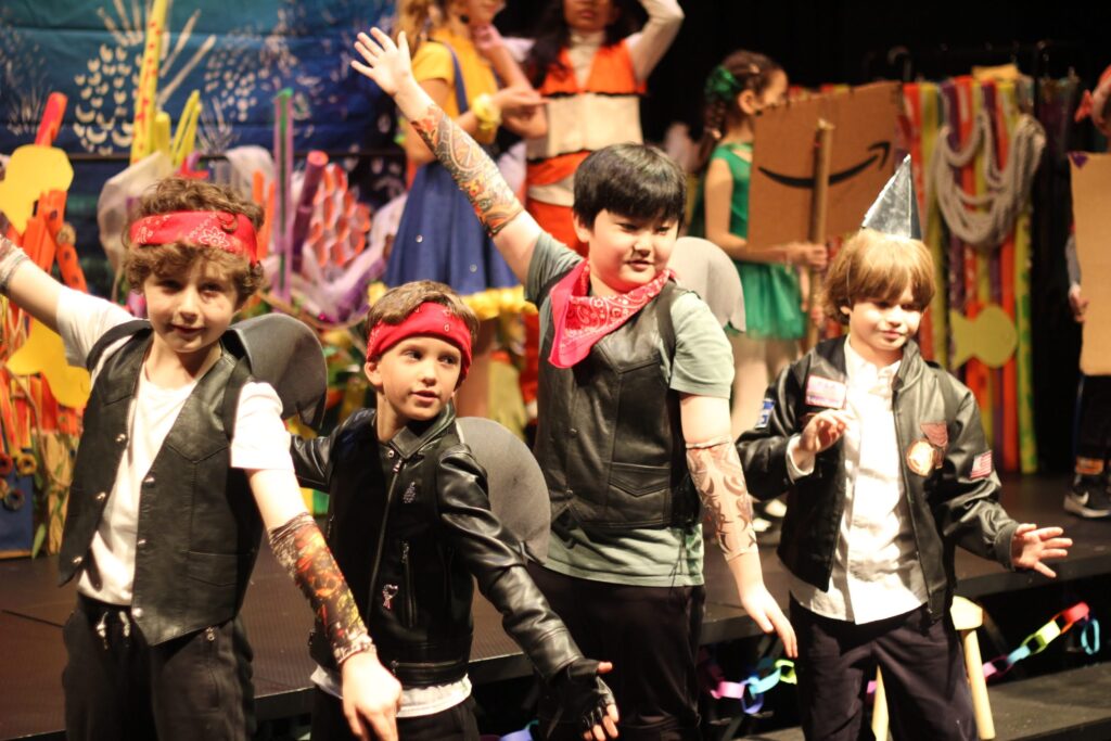 students as the sharks hold a pose perform drama club musical finding nemo