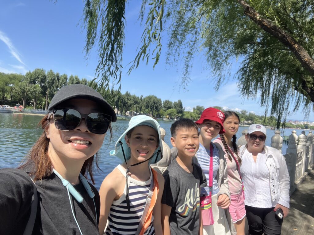 Ms. Ye and Ms. Collins stand riverside with the students exploring China
