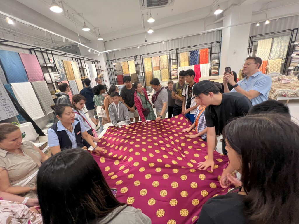 students learning about silk production at a silk factory