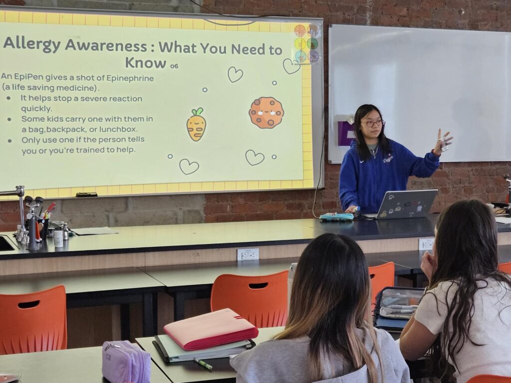 student presenting to her peers in the classroom