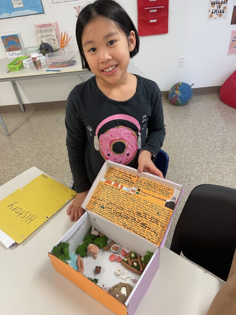 grade 4 student shows her history diorama and research writing project