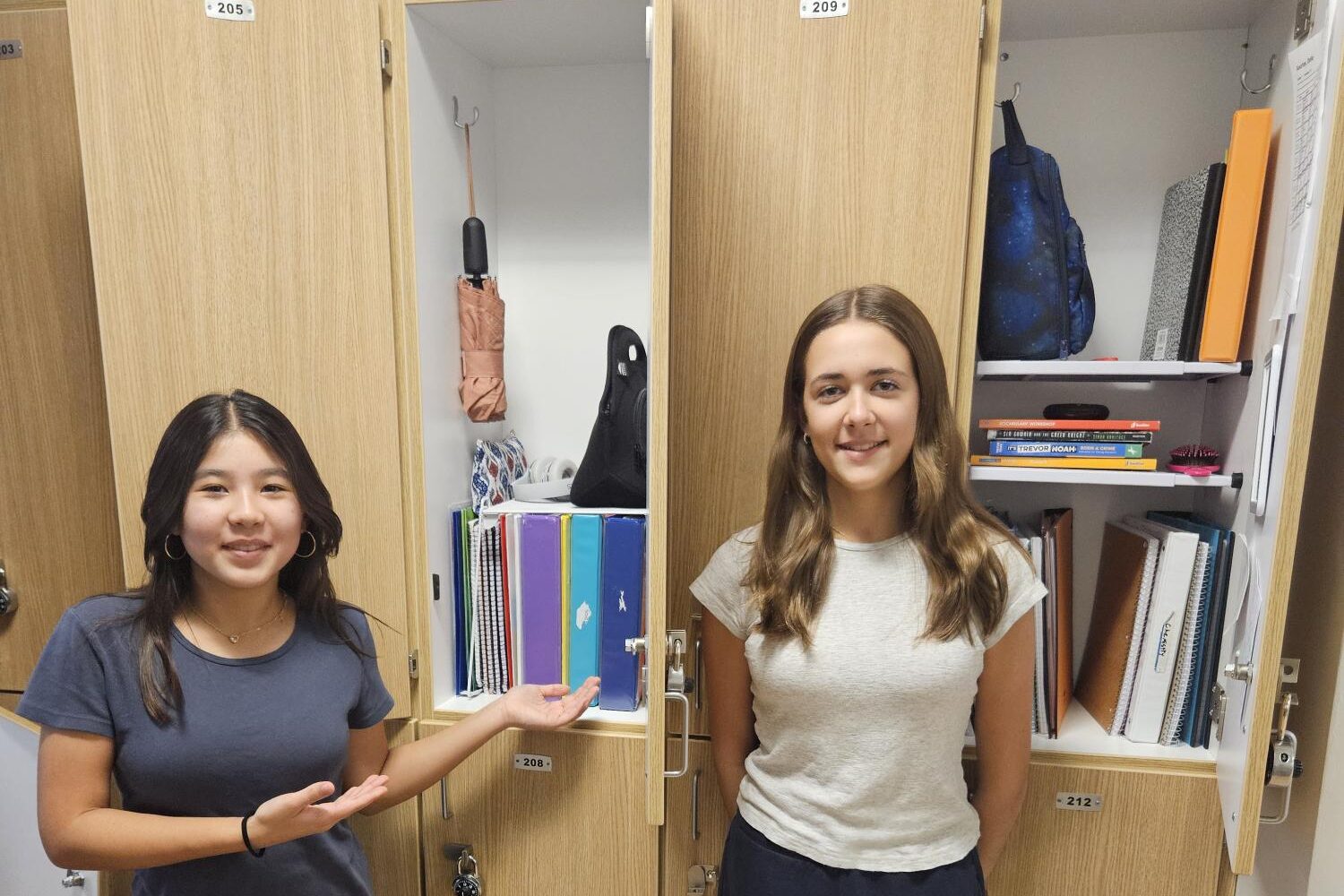 two female students in front of their organized lockers