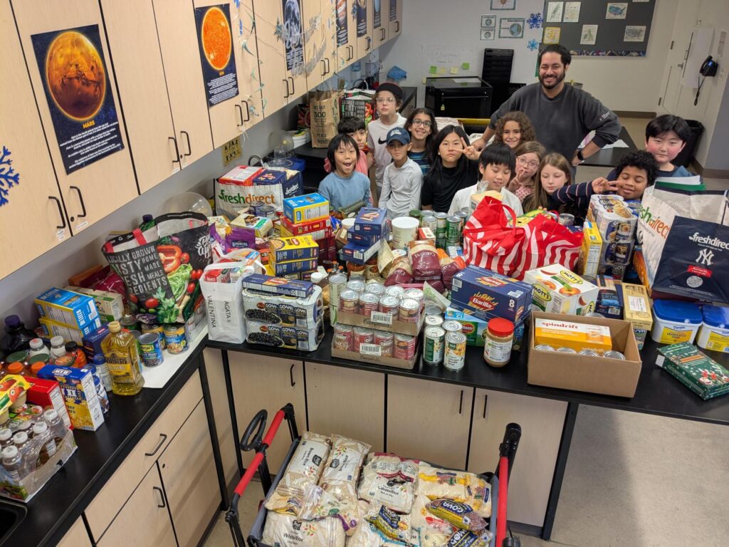 students and teacher with over 1000 pounds of food donations