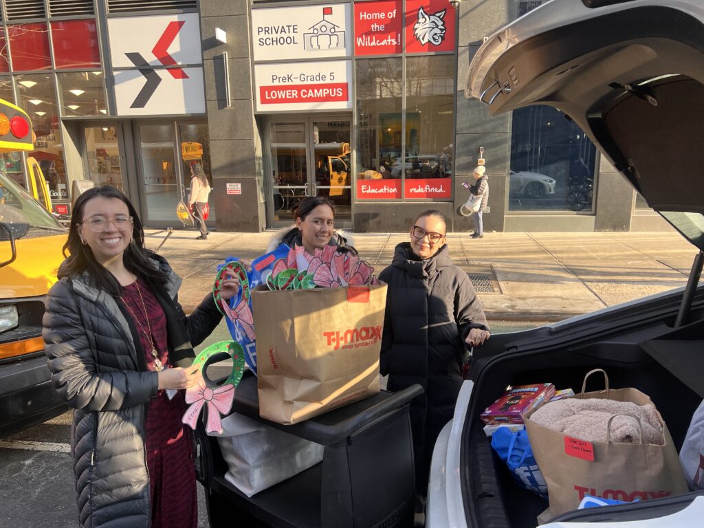 staff loading up donations for the settlement house with handmade cards