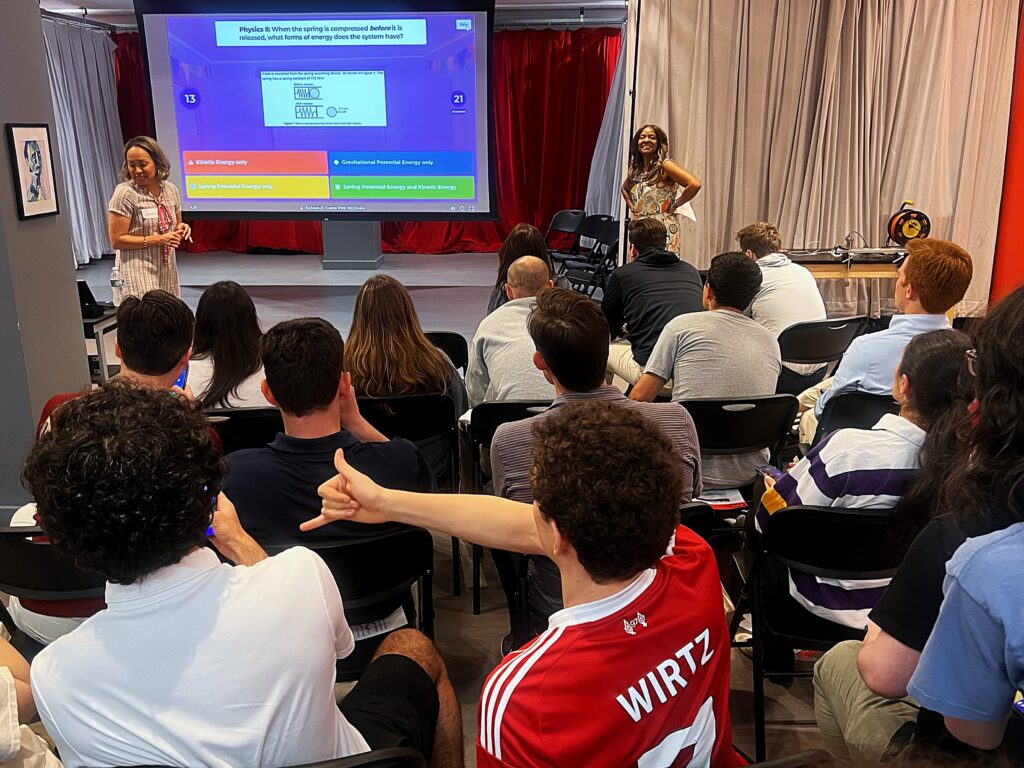a kahoot quiz with a physics question appears on the presentation screen in front of the audience